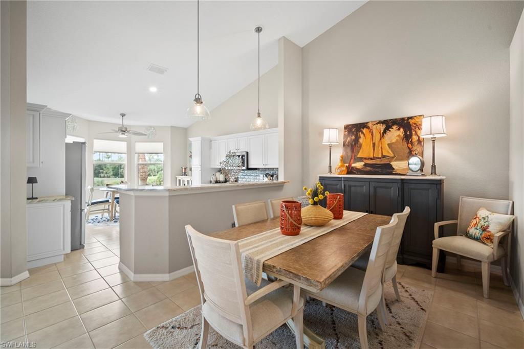 20051 Seagrove Street, Unit 1207 Estero, FL 33928 - Photo 13 of 32 a dining room with furniture a window and kitchen view