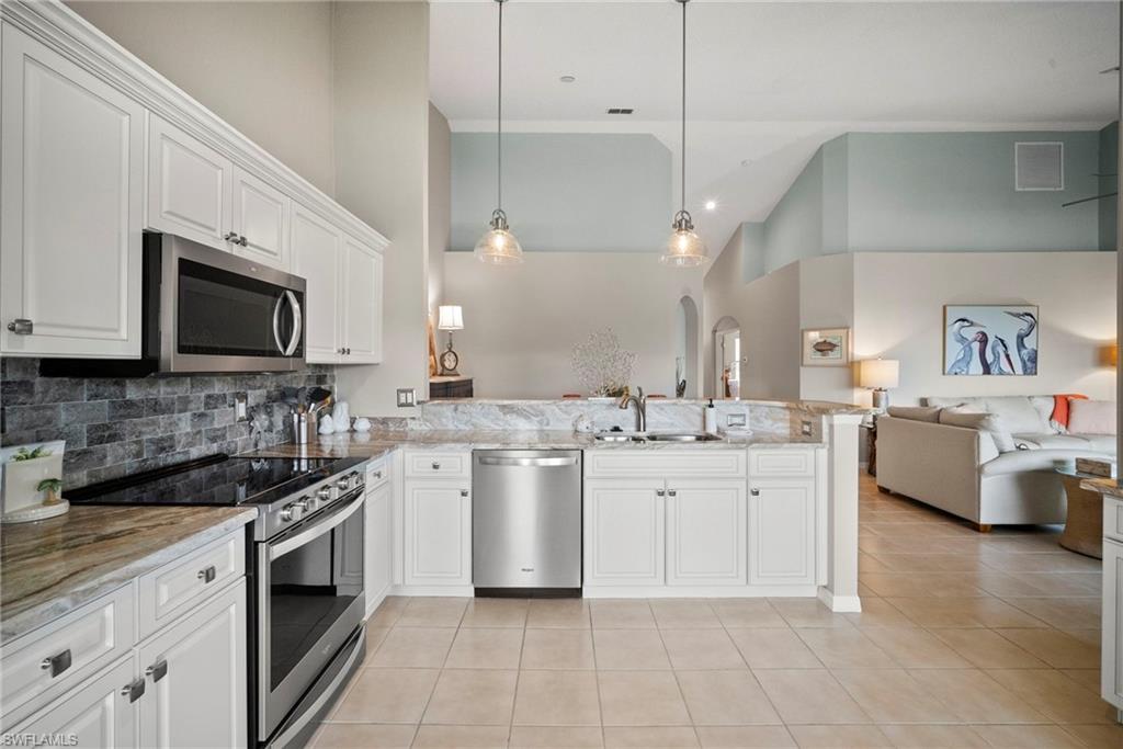 20051 Seagrove Street, Unit 1207 Estero, FL 33928 - Photo 15 of 32 a kitchen with a sink stove and microwave