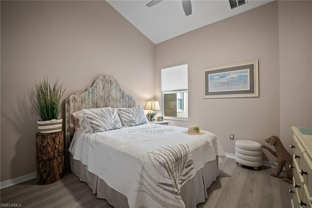 20051 Seagrove Street, Unit 1207 Estero, FL 33928 - Photo 20 of 32 a bedroom with a bed and wooden floor