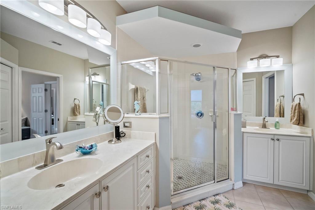 20051 Seagrove Street, Unit 1207 Estero, FL 33928 - Photo 22 of 32 a bathroom with a shower sink double and mirror