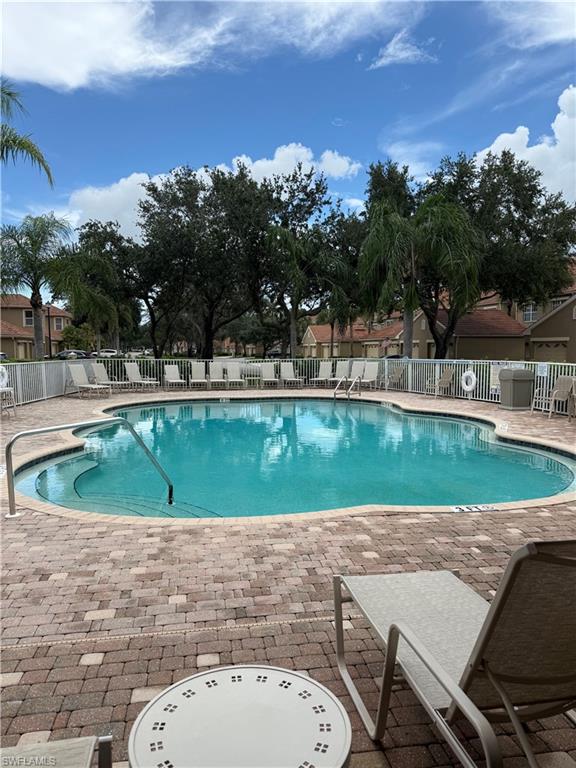 20051 Seagrove Street, Unit 1207 Estero, FL 33928 - Photo 25 of 32 a view of a swimming pool and a yard