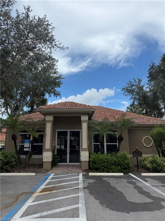 20051 Seagrove Street, Unit 1207 Estero, FL 33928 - Photo 26 of 32 a front view of a house with garden