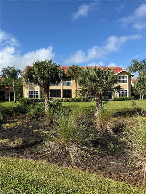 20051 Seagrove Street, Unit 1207 Estero, FL 33928 - Photo 28 of 32 a view of a lake with a house in the background