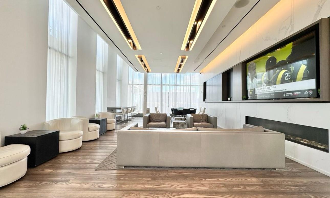 a living room with furniture and large windows