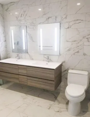 a bathroom with a sink toilet and mirror