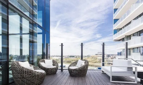a view of balcony with couch and chairs