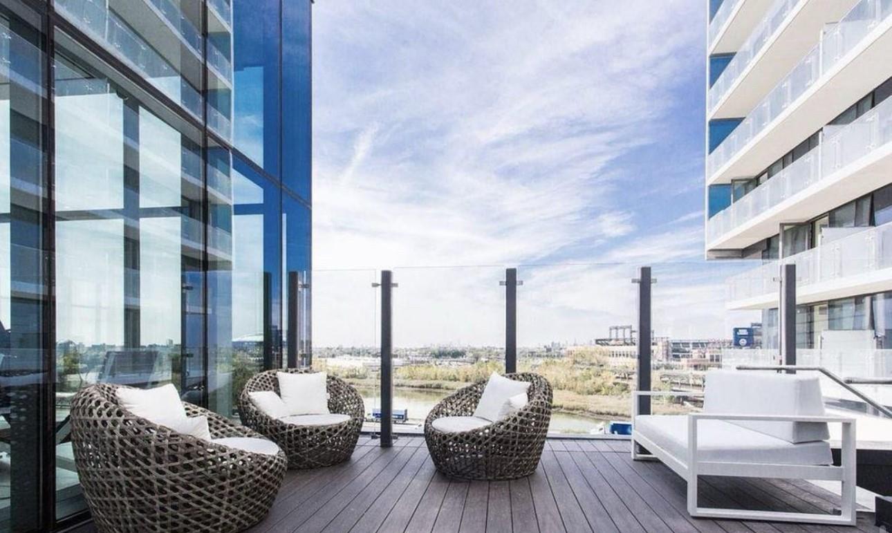 131-01 40 Road, Unit 10C Queens, NY 11354 - Photo 7 of 9 a view of balcony with couch and chairs