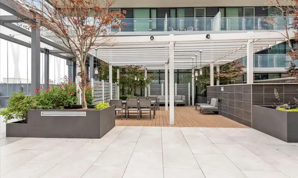 a view of a patio with a table and chairs and potted plants