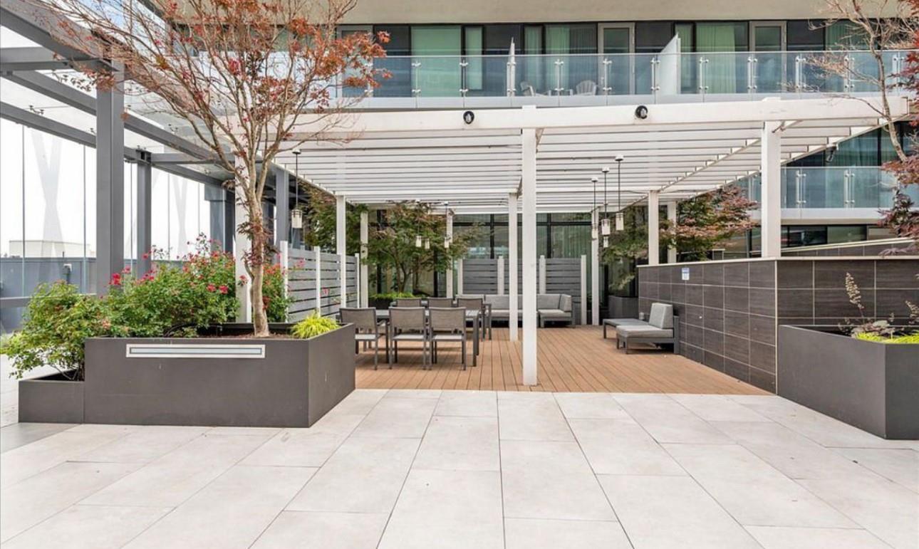 131-01 40 Road, Unit 10C Queens, NY 11354 - Photo 8 of 9 a view of a patio with a table and chairs and potted plants