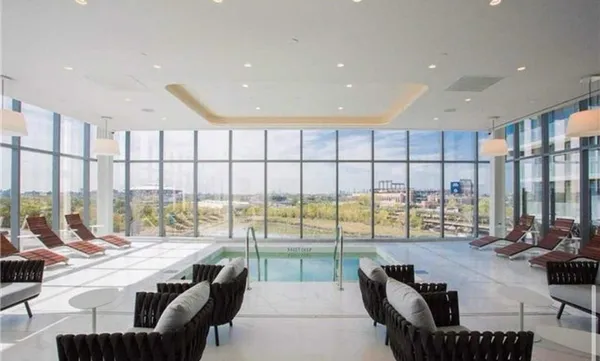 a living room with furniture and a floor to ceiling window