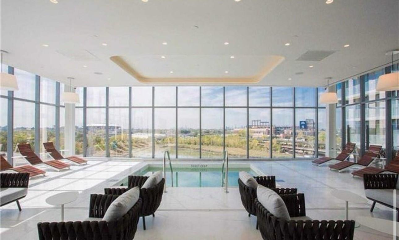 131-01 40 Road, Unit 10C Queens, NY 11354 - Photo 9 of 9 a living room with furniture and a floor to ceiling window