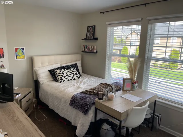 a bedroom with a bed dresser and a window