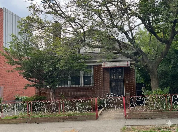 a view of a house with a tree