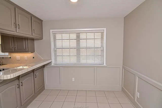 a kitchen with white cabinets and a sink