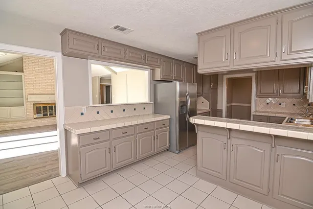 a spacious bathroom with a granite countertop sink and a mirror
