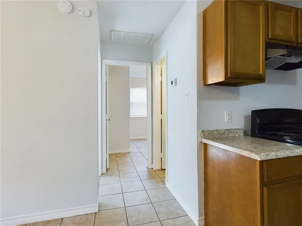 a bathroom with a granite countertop sink a toilet and bathtub