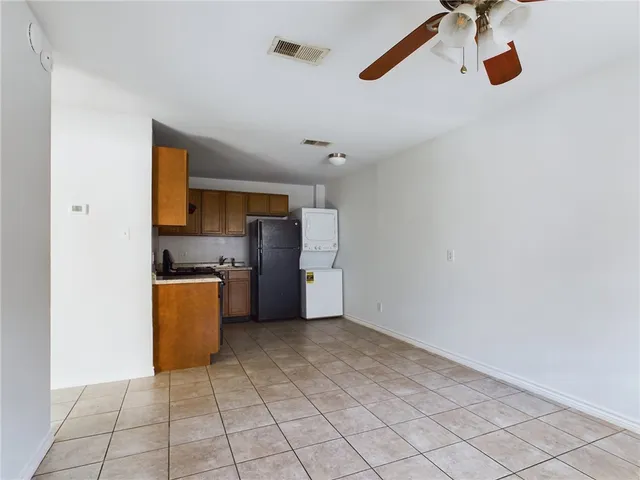 a kitchen with stainless steel appliances granite countertop a sink a stove top oven a counter space and cabinets