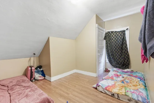 a bedroom with a bed and a painting on the wall