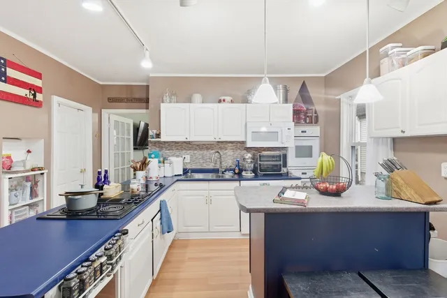 a kitchen with a sink stove and cabinets