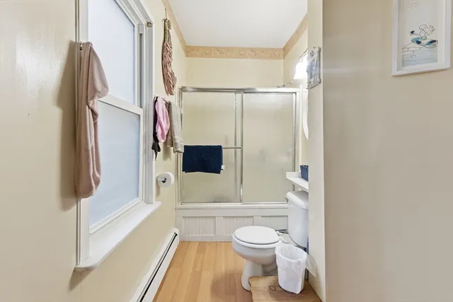 a bathroom with a toilet and a shower