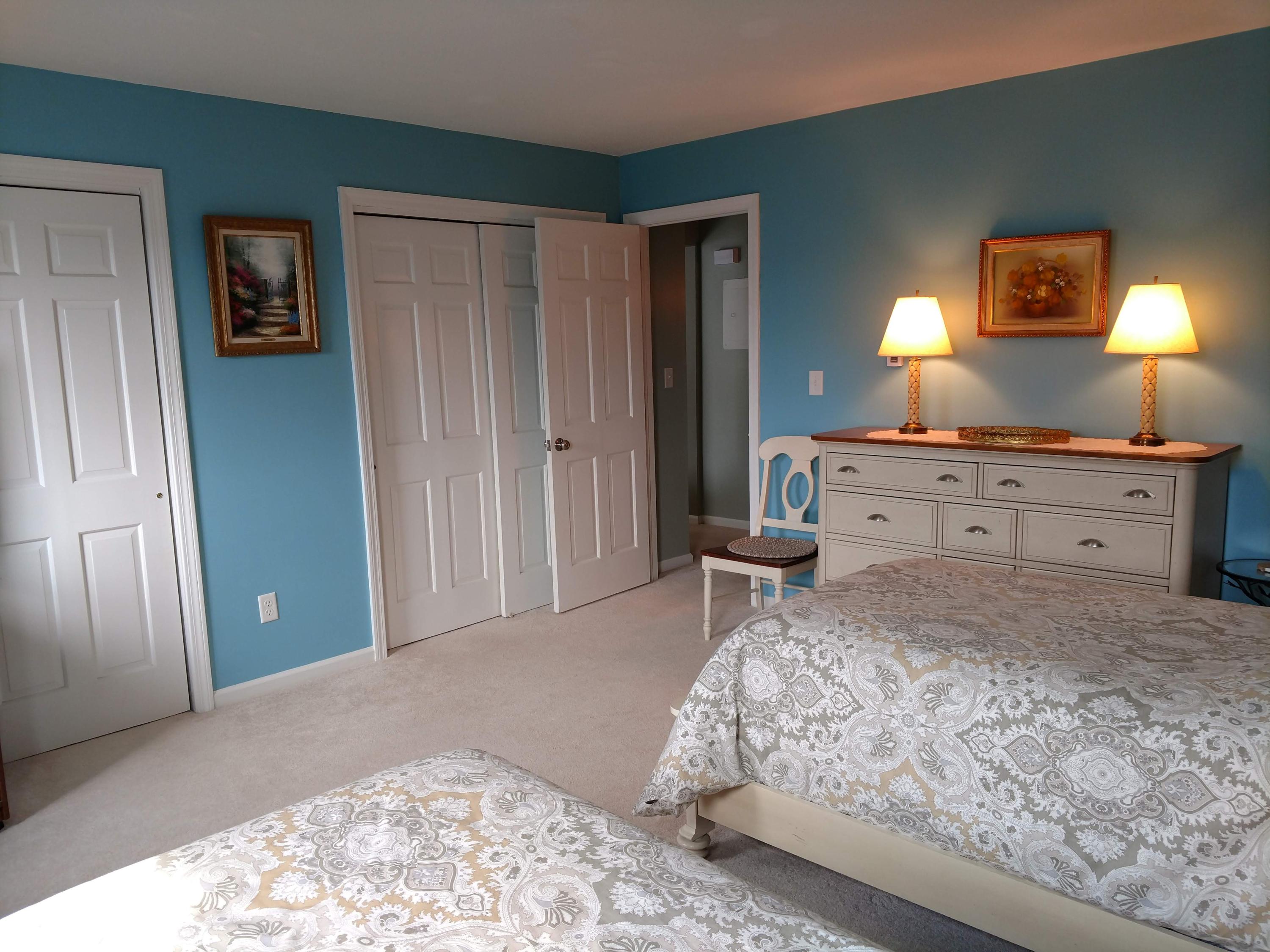 683 Old Post Road, Unit U18 Dennis, MA 02638 - Photo 11 of 26 a spacious bedroom with a bed and a dresser in it