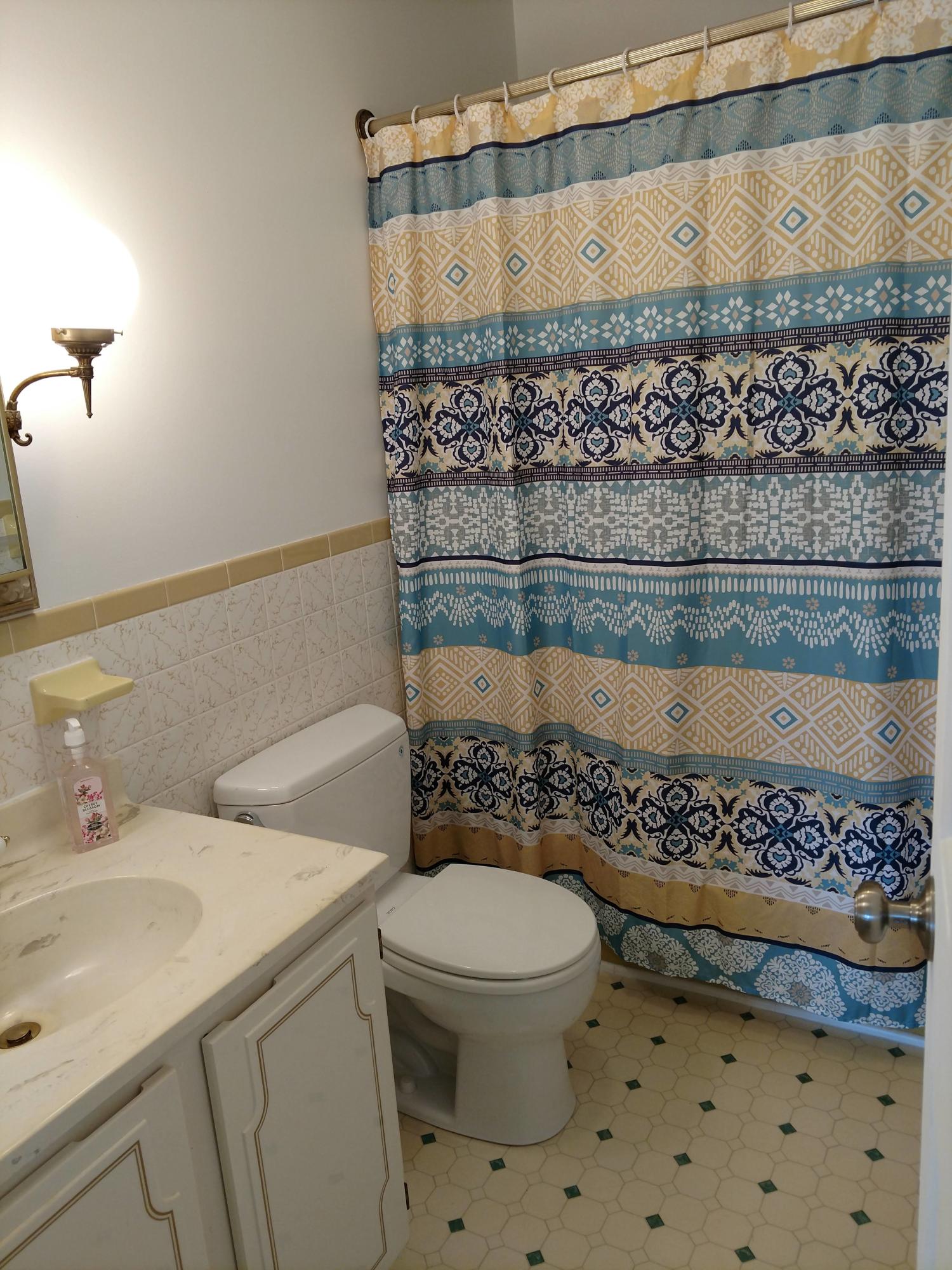 683 Old Post Road, Unit U18 Dennis, MA 02638 - Photo 12 of 26 a bathroom with a sink a toilet and a mirror