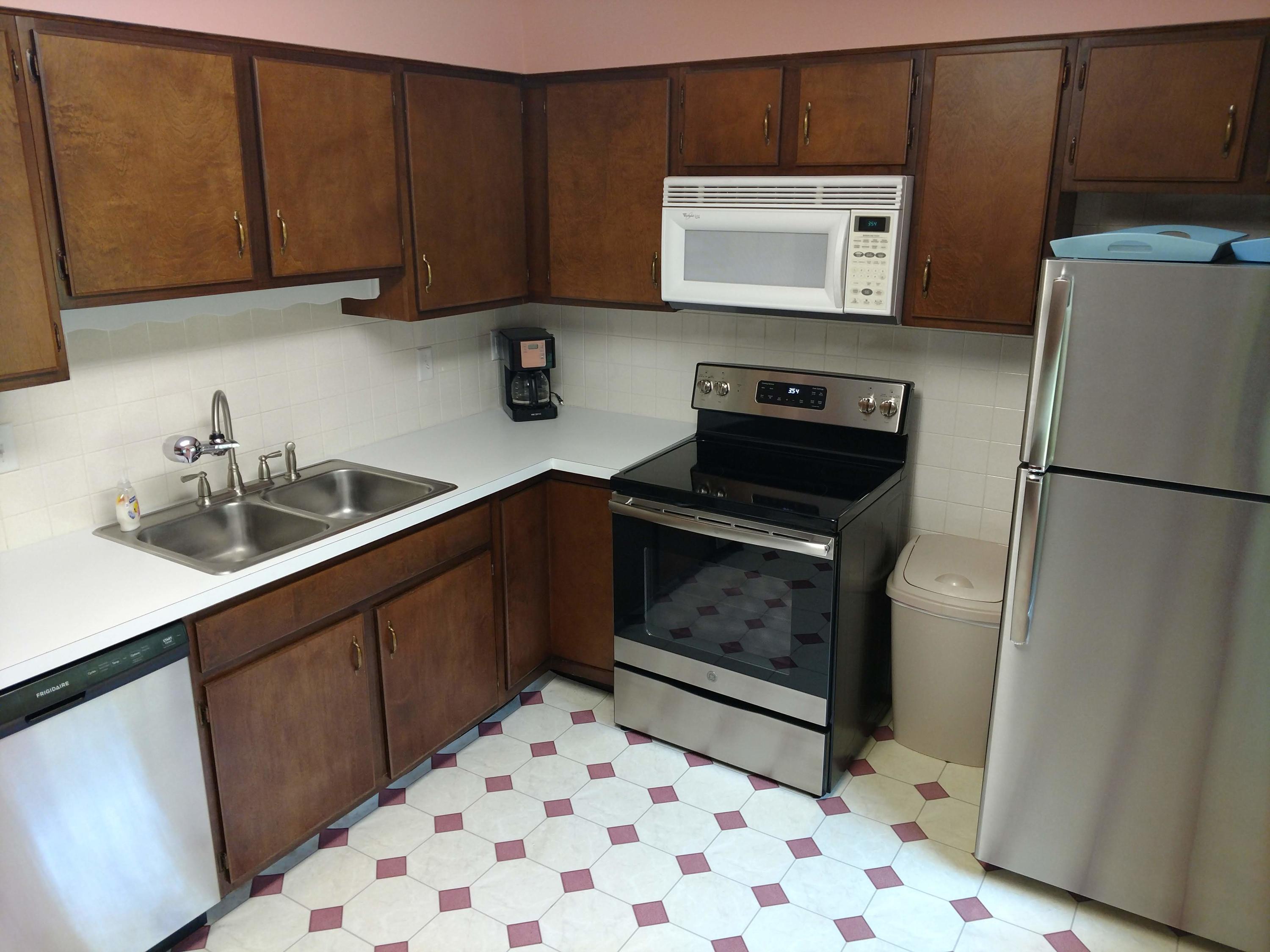 683 Old Post Road, Unit U18 Dennis, MA 02638 - Photo 16 of 26 a kitchen with a sink stove and refrigerator