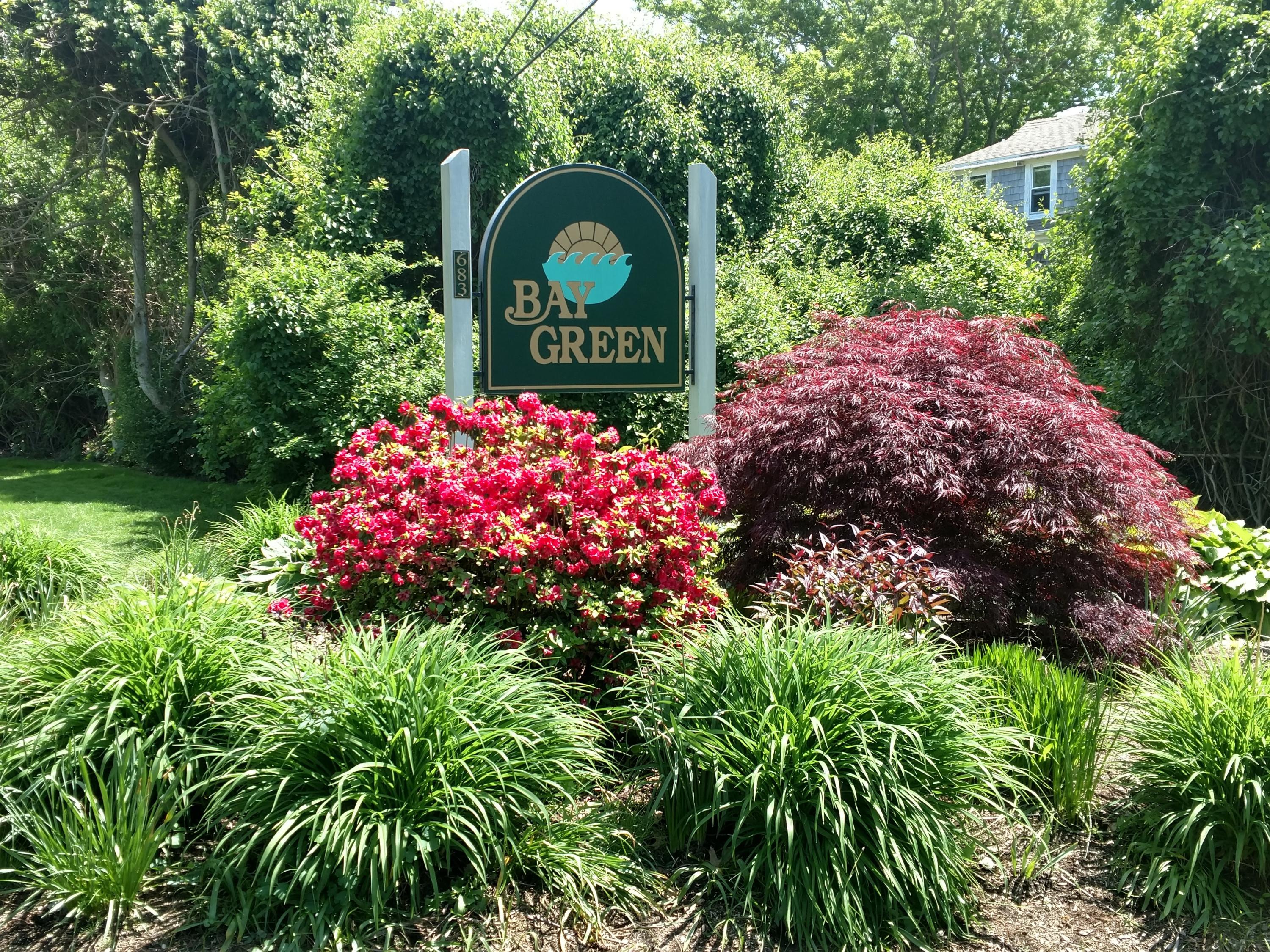 683 Old Post Road, Unit U18 Dennis, MA 02638 - Photo 26 of 26 a sign that is sitting in front of flowers
