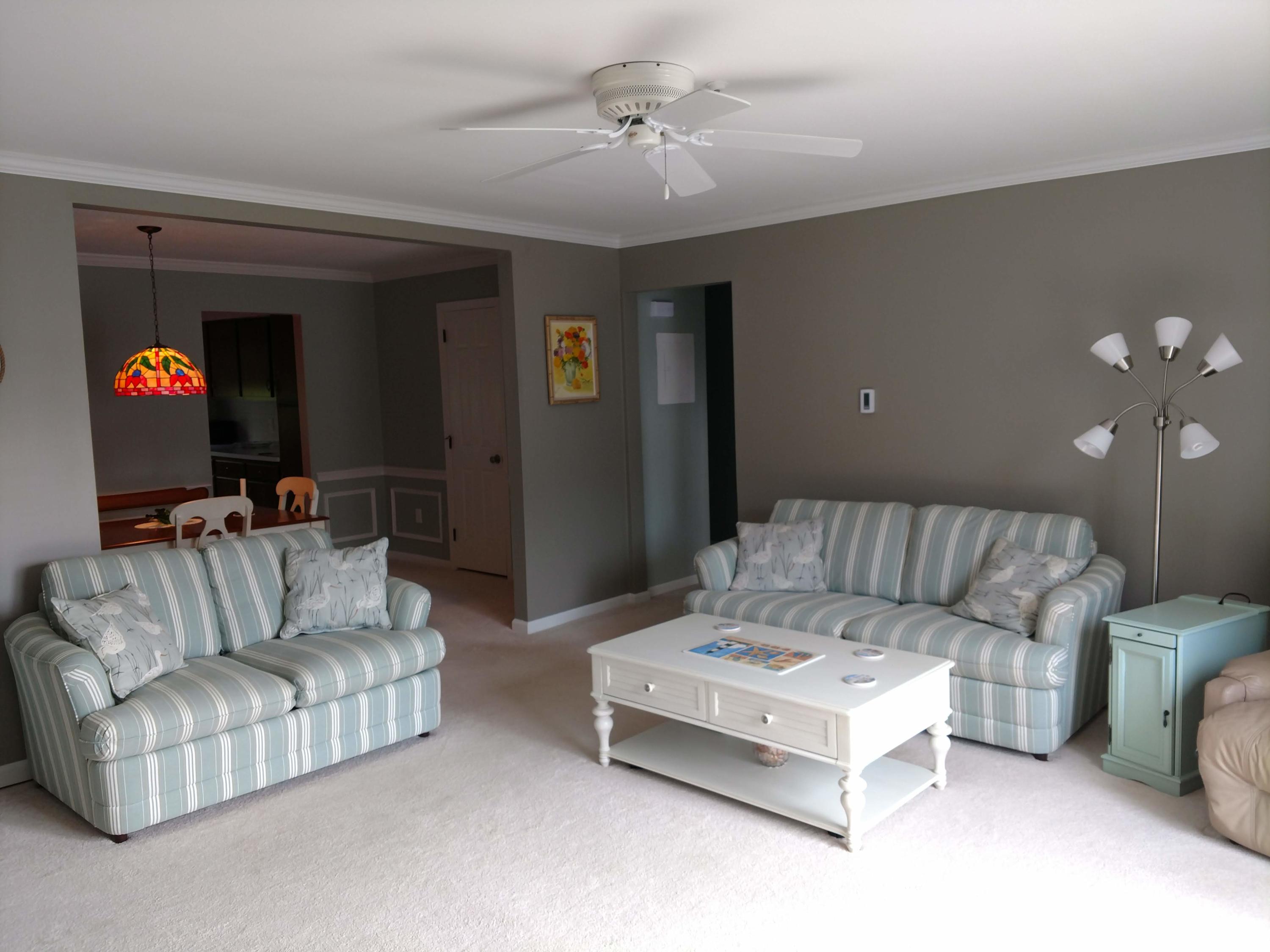 683 Old Post Road, Unit U18 Dennis, MA 02638 - Photo 5 of 26 a living room with furniture and a ceiling fan