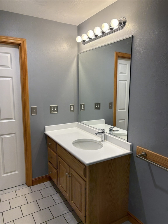 1 1/2 Main Street, Unit B Spencer, MA 01562 - Photo 14 of 18 a bathroom with a sink and a mirror