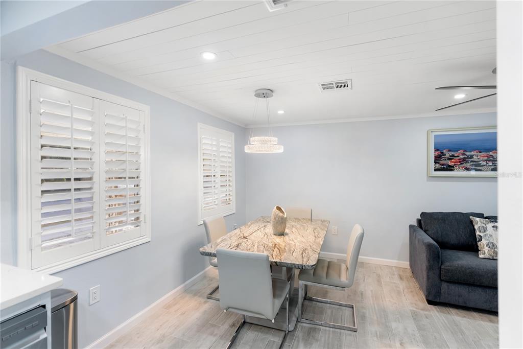9022 Midnight Pass Road, Unit 112 Sarasota, FL 34242 - Photo 15 of 40 a view of a dining room with furniture and a window