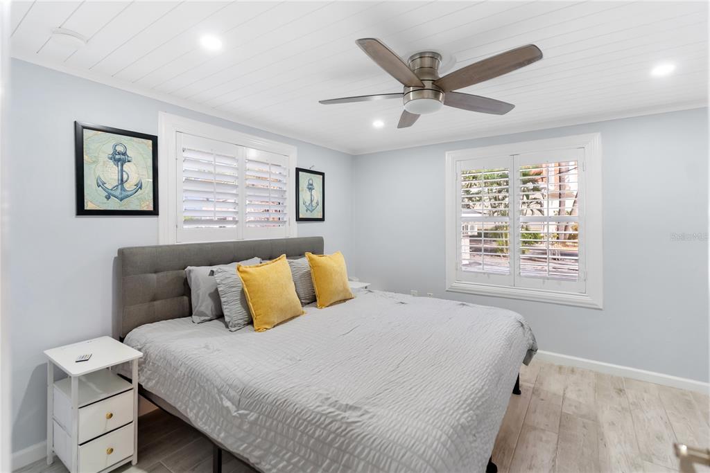 9022 Midnight Pass Road, Unit 112 Sarasota, FL 34242 - Photo 16 of 40 a bedroom with a bed and window