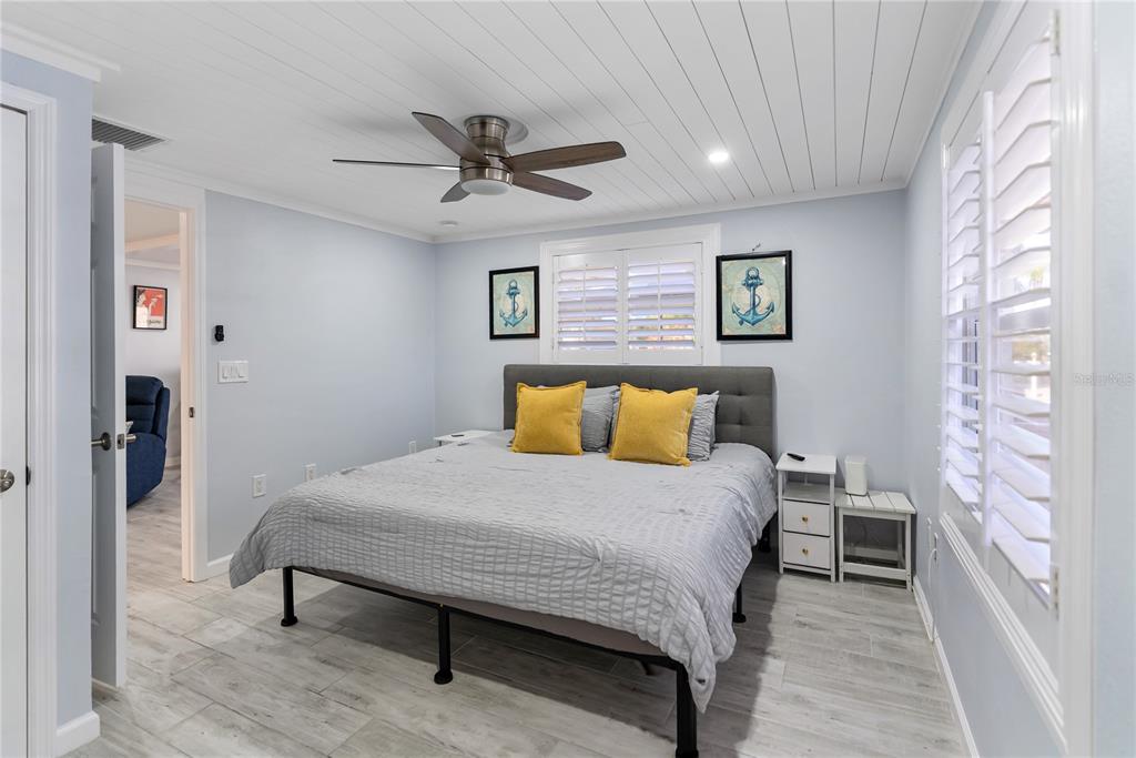 9022 Midnight Pass Road, Unit 112 Sarasota, FL 34242 - Photo 17 of 40 a bedroom with a bed and a table