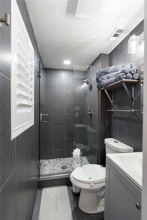 9022 Midnight Pass Road, Unit 112 Sarasota, FL 34242 - Photo 19 of 40 a bathroom with a sink a toilet and shower