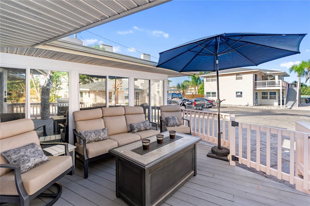 9022 Midnight Pass Road, Unit 112 Sarasota, FL 34242 - Photo 20 of 40 a living room with furniture and a ceiling fan