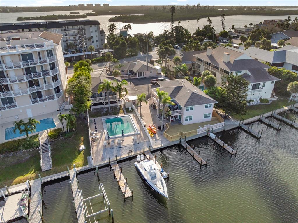 9022 Midnight Pass Road, Unit 112 Sarasota, FL 34242 - Photo 2 of 40 an aerial view of residential houses with outdoor space