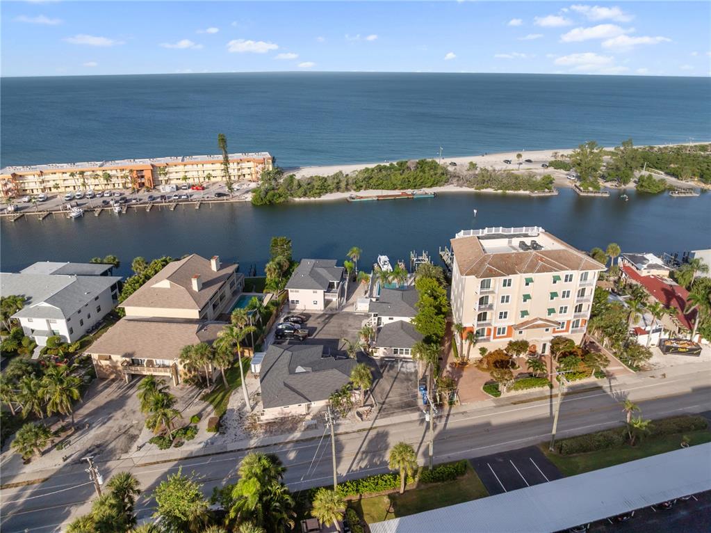 9022 Midnight Pass Road, Unit 112 Sarasota, FL 34242 - Photo 25 of 40 an aerial view of ocean and residential houses with outdoor space
