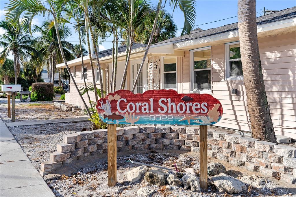 9022 Midnight Pass Road, Unit 112 Sarasota, FL 34242 - Photo 3 of 40 a sign on the side of a road