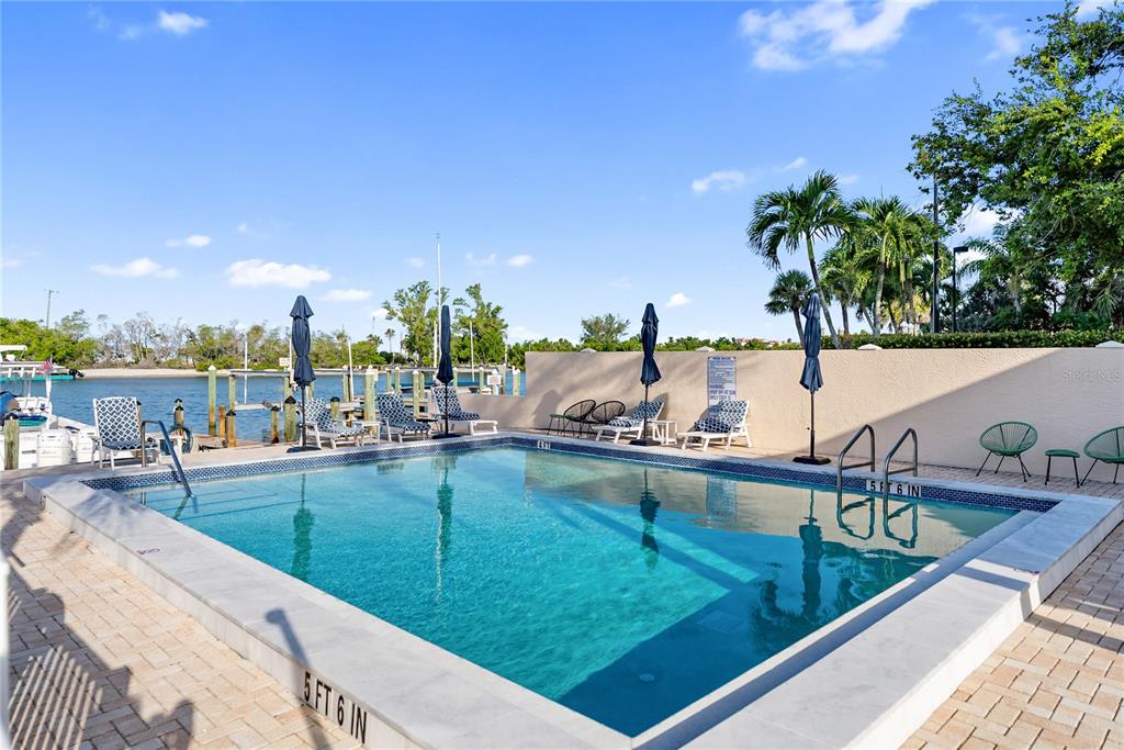 9022 Midnight Pass Road, Unit 112 Sarasota, FL 34242 - Photo 33 of 40 a view of swimming pool from a balcony