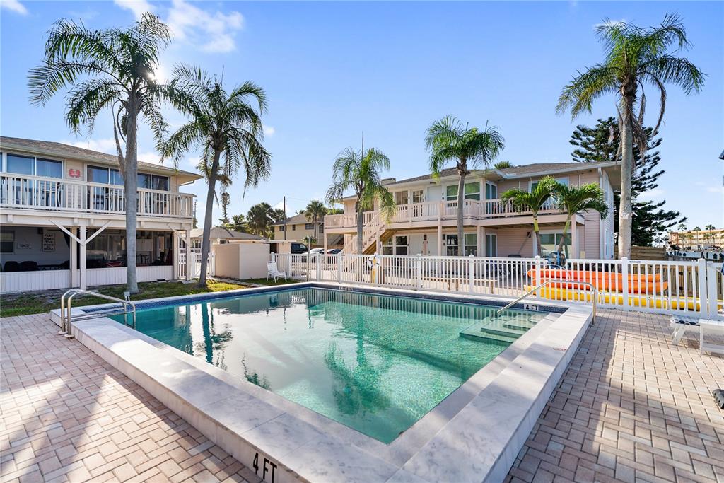 9022 Midnight Pass Road, Unit 112 Sarasota, FL 34242 - Photo 38 of 40 a view of a house with swimming pool and sitting area