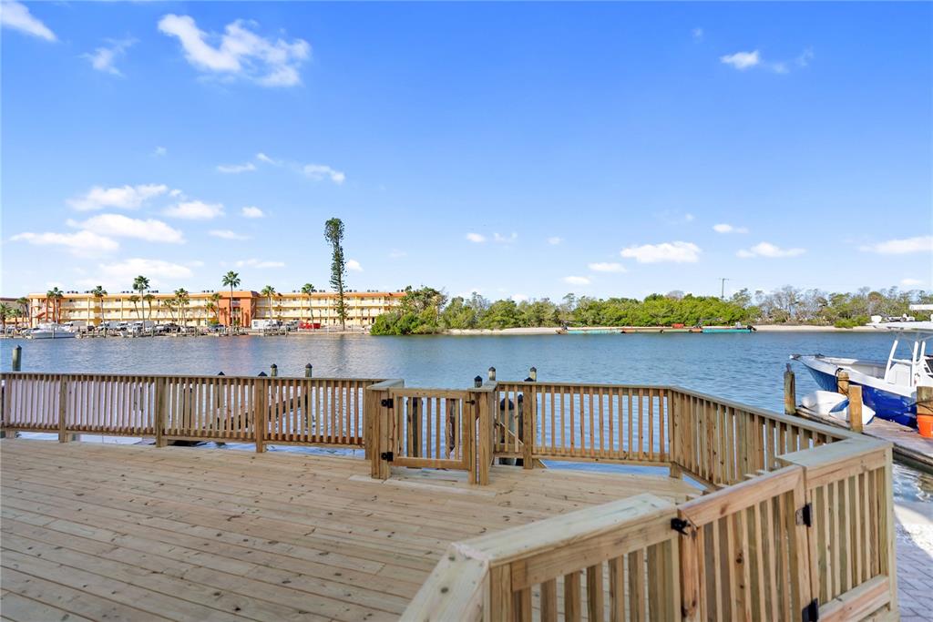 9022 Midnight Pass Road, Unit 112 Sarasota, FL 34242 - Photo 39 of 40 a view of a lake with houses in the background