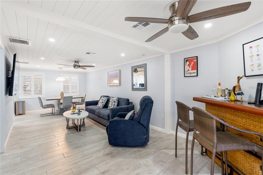 9022 Midnight Pass Road, Unit 112 Sarasota, FL 34242 - Photo 5 of 40 a living room with furniture and a wooden floor