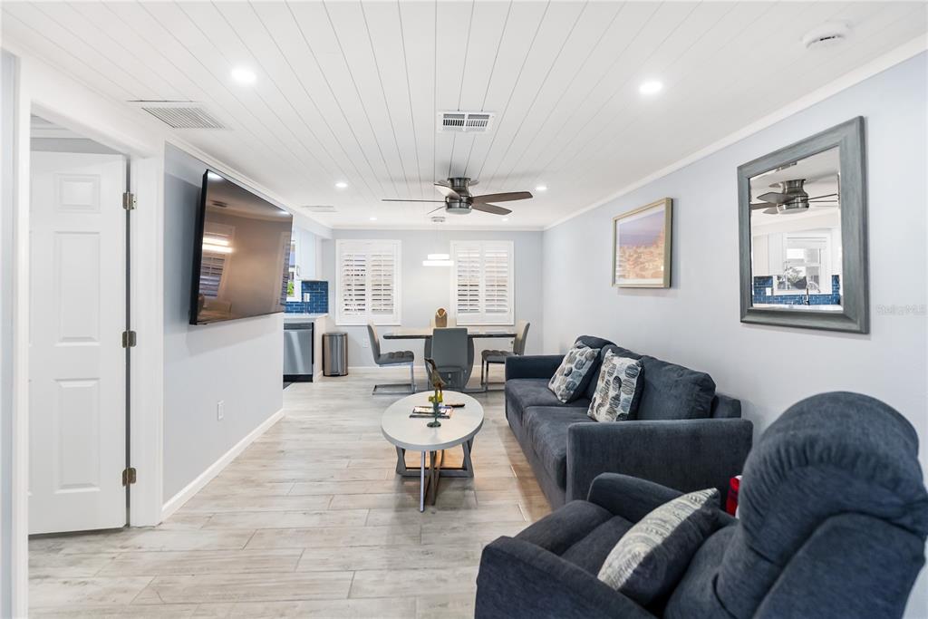 9022 Midnight Pass Road, Unit 112 Sarasota, FL 34242 - Photo 6 of 40 a living room with furniture and a view of kitchen