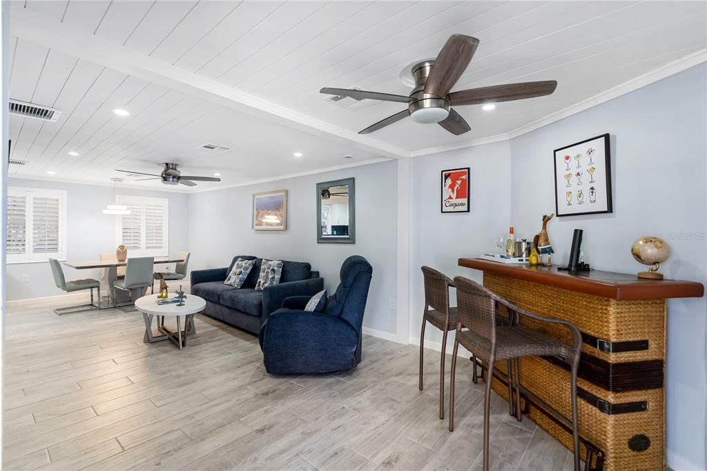 9022 Midnight Pass Road, Unit 112 Sarasota, FL 34242 - Photo 8 of 40 a living room with furniture and a wooden floor