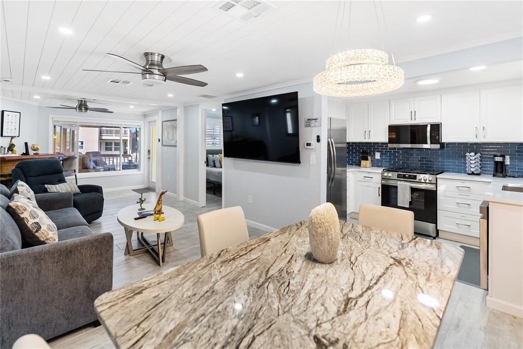 9022 Midnight Pass Road, Unit 112 Sarasota, FL 34242 - Photo 10 of 40 a living room with furniture and a flat screen tv