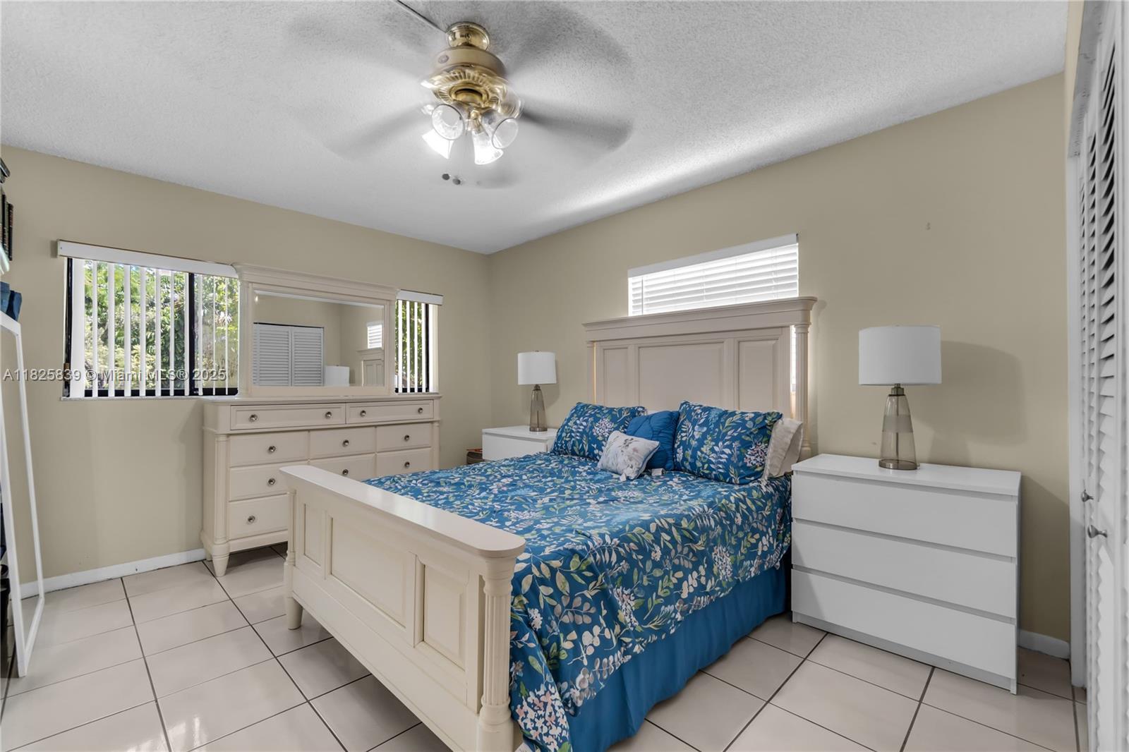 8400 Southwest 133rd Avenue Road, Unit 212 Miami, FL 33183 - Photo 12 of 32 a bedroom with a bed and a dresser