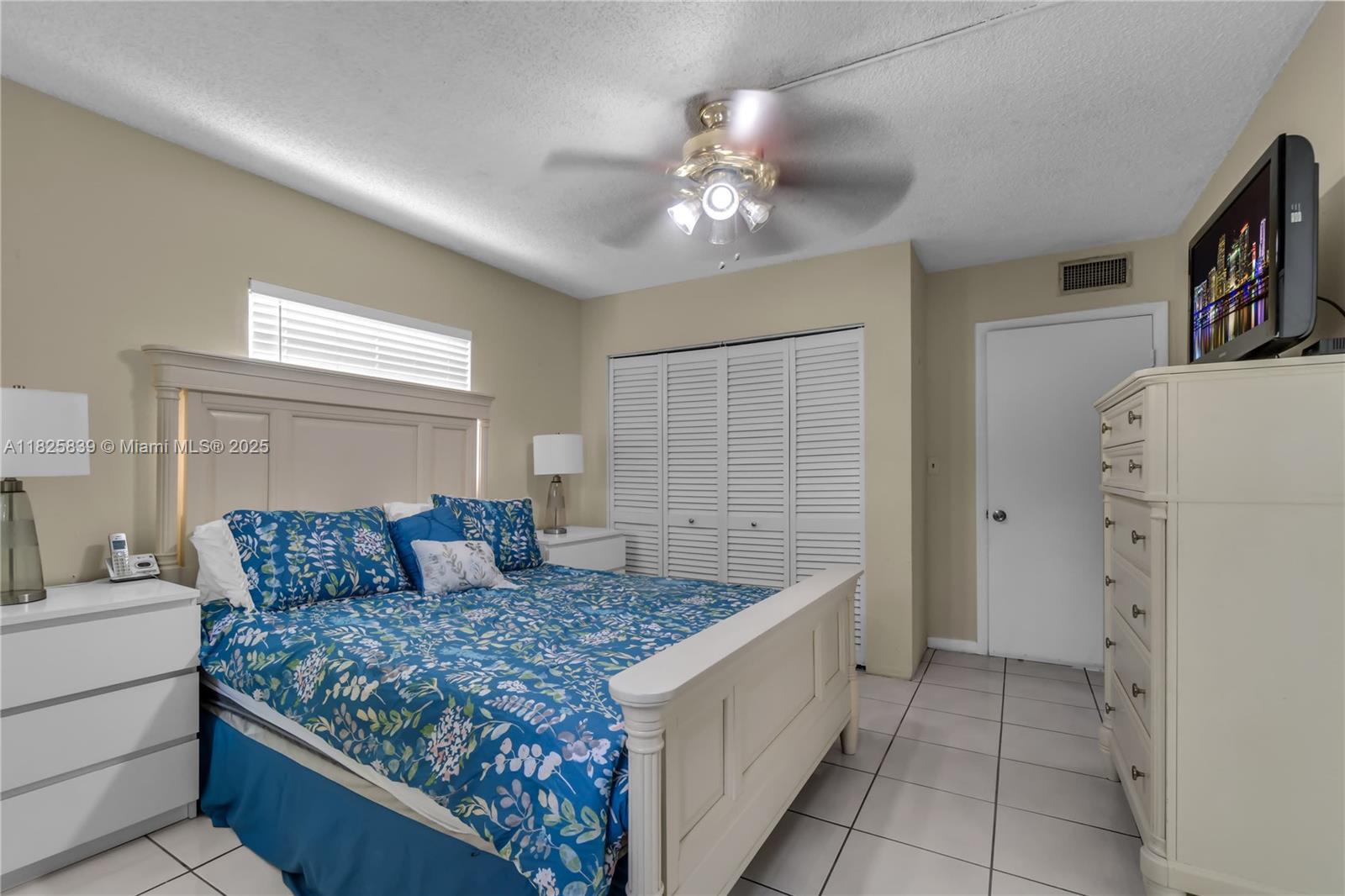 8400 Southwest 133rd Avenue Road, Unit 212 Miami, FL 33183 - Photo 13 of 32 a bedroom with a large bed and a couch
