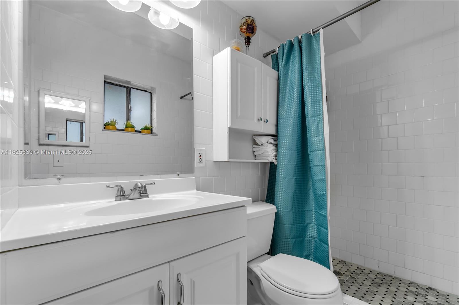 8400 Southwest 133rd Avenue Road, Unit 212 Miami, FL 33183 - Photo 14 of 32 a bathroom with a sink a toilet and shower