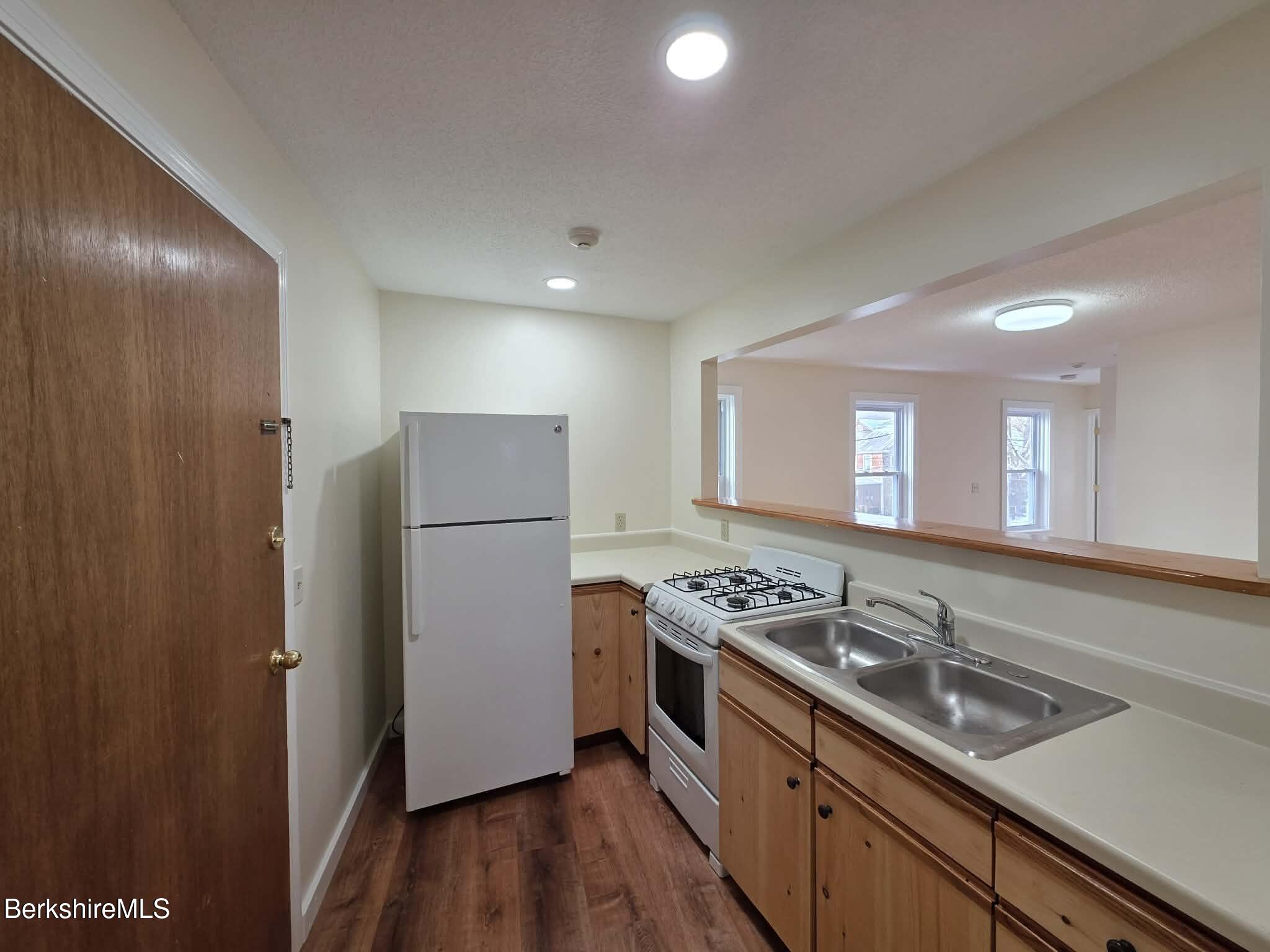 19 Pleasant Street, Unit 2B Adams, MA 01220 - Photo 4 of 14 a kitchen that has a sink stove and refrigerator
