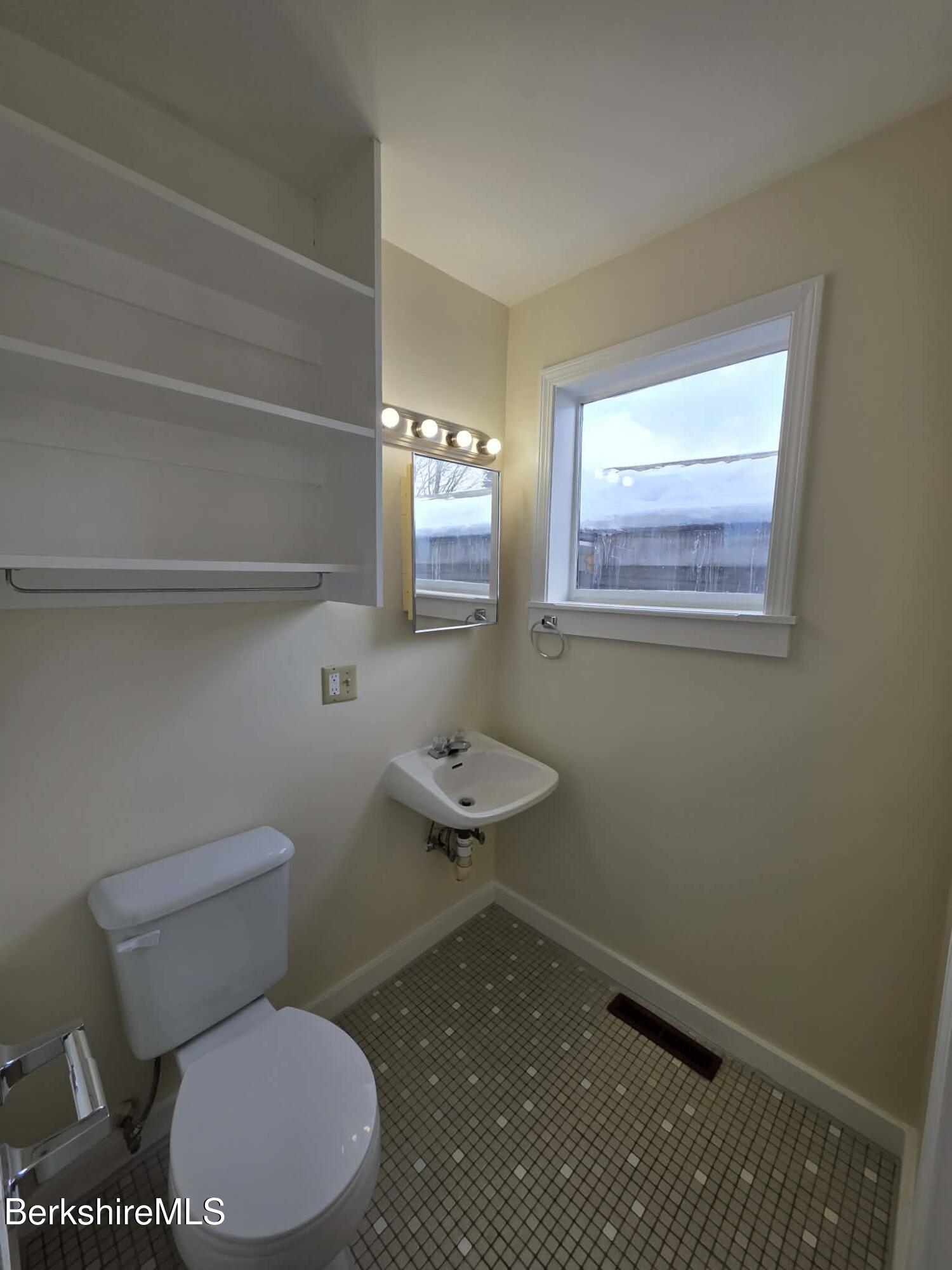 19 Pleasant Street, Unit 2B Adams, MA 01220 - Photo 9 of 14 a bathroom with a toilet a sink and a window